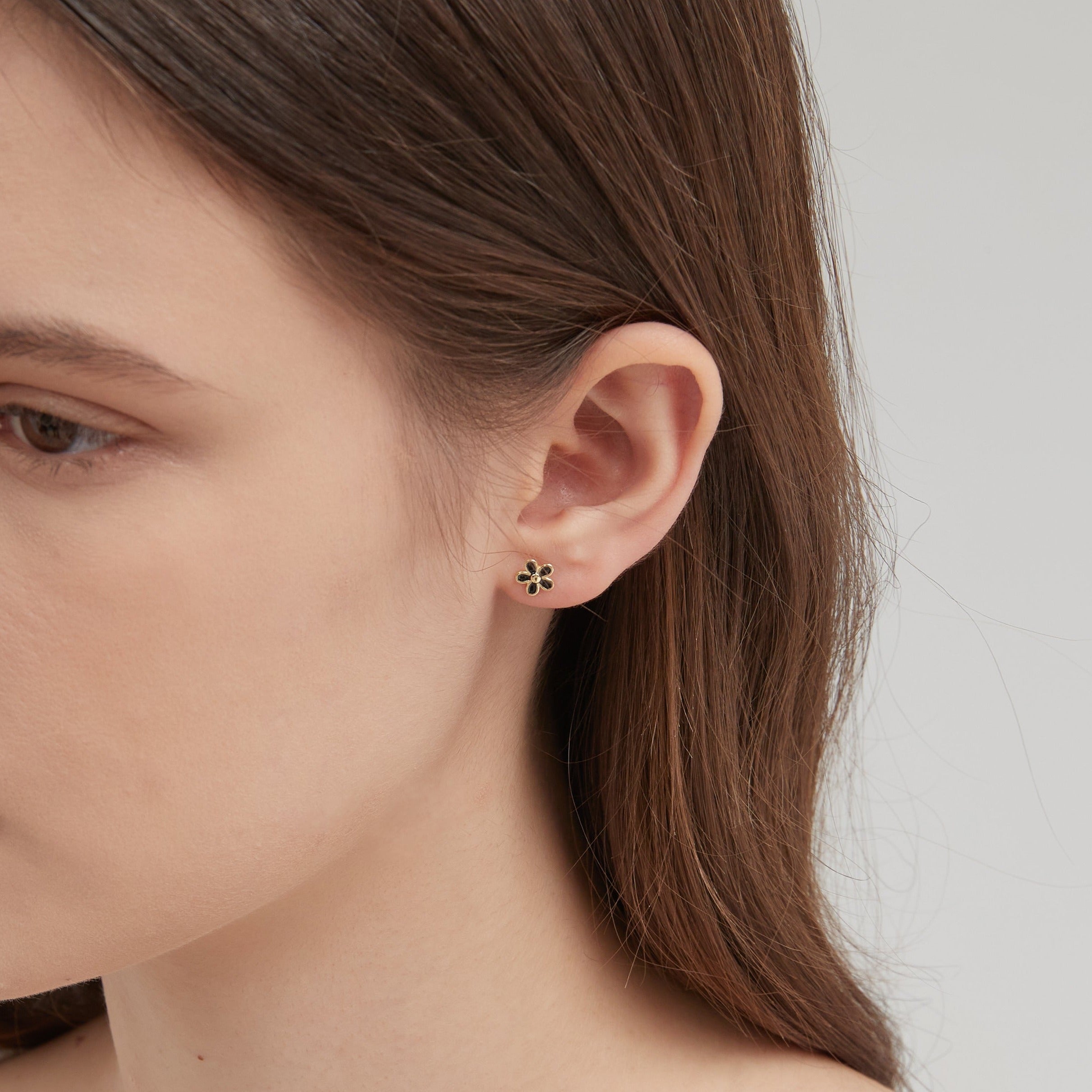 STMG Tiny Black Flower Stud Earrings on ear