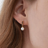 STMG Pearl Dangle Earrings on ear
