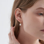 STMG Pearl Dangle Hoops in gold on ear